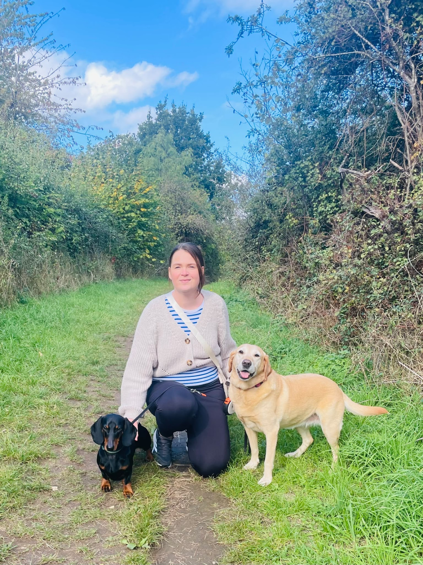 Nat with her Labrador and dachshund on a Warwickshire country path
